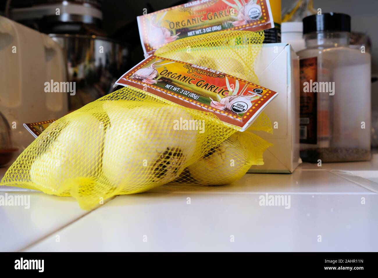 Store packaged organic garlic from Trader Joe's on a white tiled