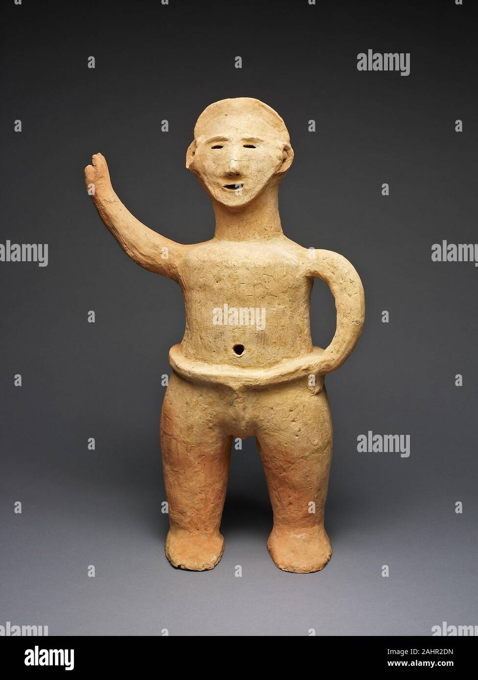 Wrestler. 300 AD–522 AD. Japan. Earthenware This wrestler or rikishi is  wearing a simple headband and a wrestler's harness. He stands solidly on  two feet, with a hand on his hip and