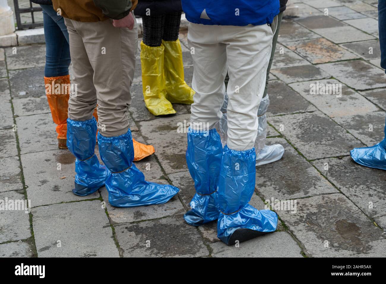 Tourists wearing plasting boots in Venice, Italy Stock Photo Alamy