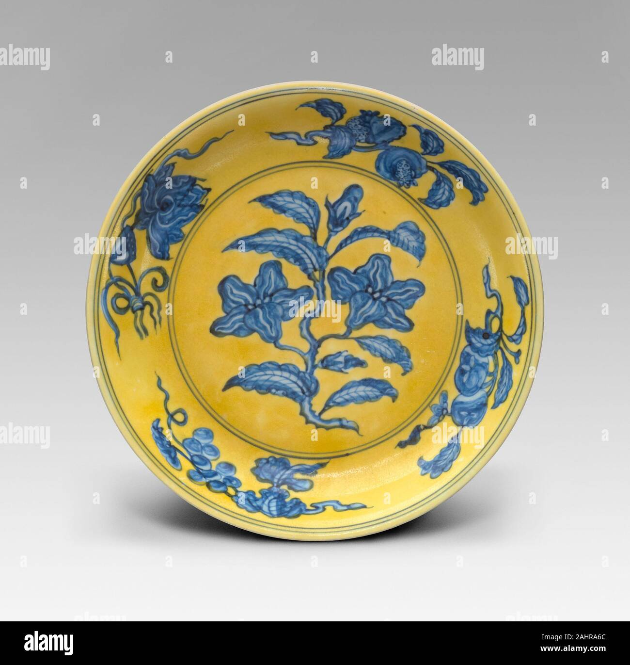 Dish with Floral and Fruit Sprays ( Gardenia Dish ). 1488–1505. Porcelain painted in underglaze blue and overglaze yellow enamel Stock Photo