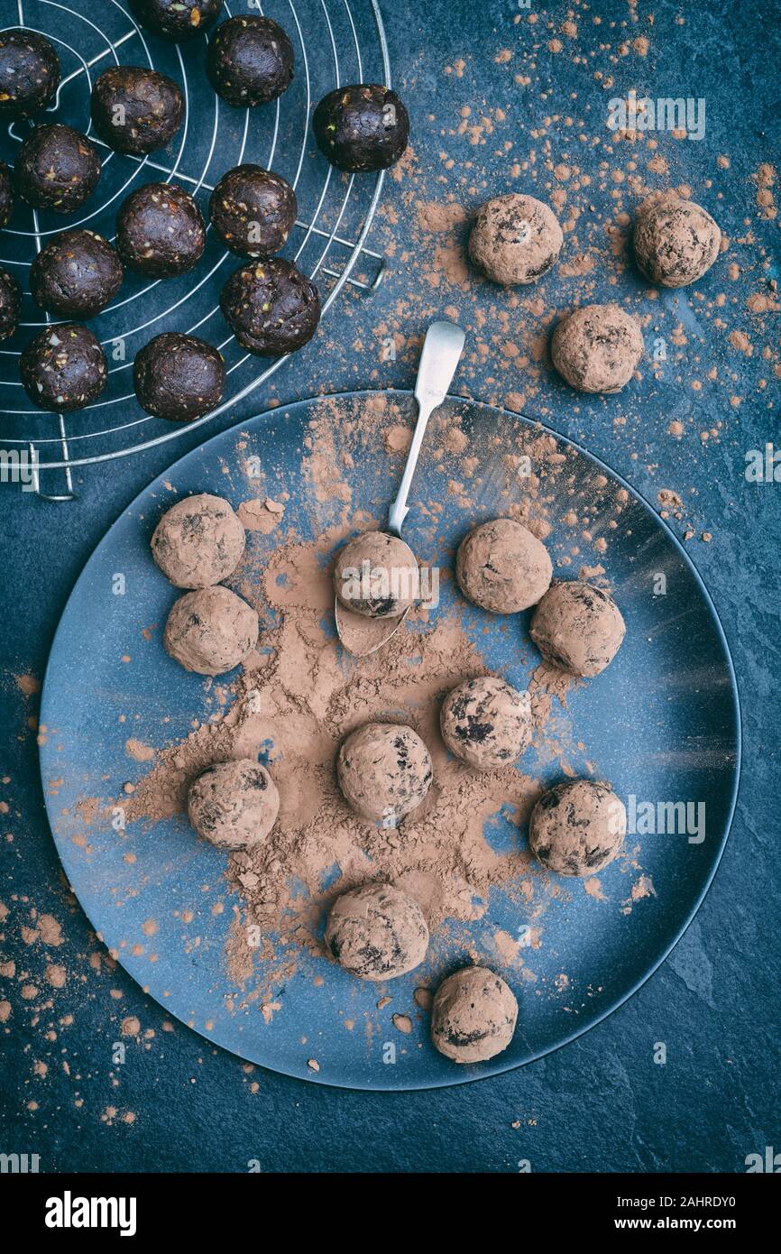 Homemade vegan cacao date cranberry and nut energy balls covered in cacao powder Stock Photo