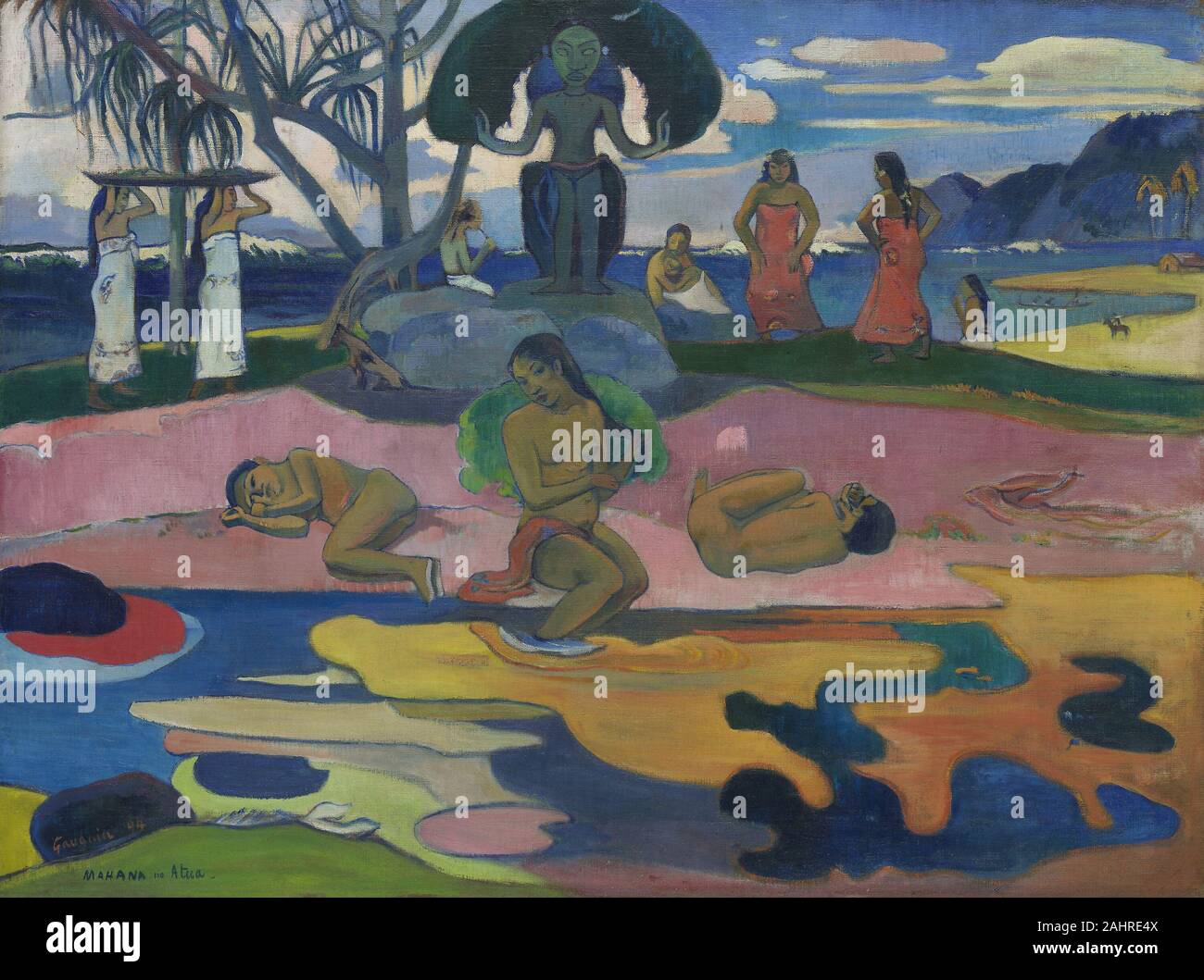 Paul Gauguin. Mahana no atua (Day of the God). 1894. France. Oil on linen canvas Day of the God is one of a small number of paintings of Tahitian subjects that Paul Gauguin made in France between his stays in the South Pacific. An imaginary rather than realistic depiction of the South Seas, it is dominated by an idol of the goddess Hina. To the right of her, women dance the upaupa, a suggestive ancient Tahitian dance that missionaries and colonial authorities tried to suppress. In a middle ground of pink sand sits a female bather flanked by ambiguously gendered figures lying on their sides. Al Stock Photo