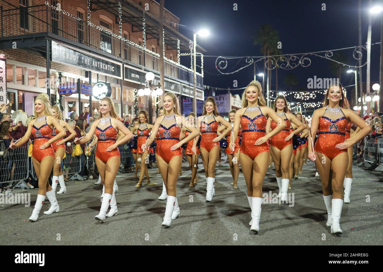 Tampa, FL, USA. 31st Dec, 2019. The Auburn majorettes march ahead of the band down Ybor City during the 2020 Outback Bowl's Battle of the Bands at Busch Gardens in Tampa, FL. Kyle Okita/CSM/Alamy Live News Stock Photo