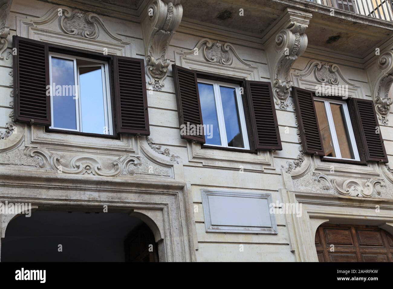 facade of ornate baroque style apartment building typical of Rome Stock Photo