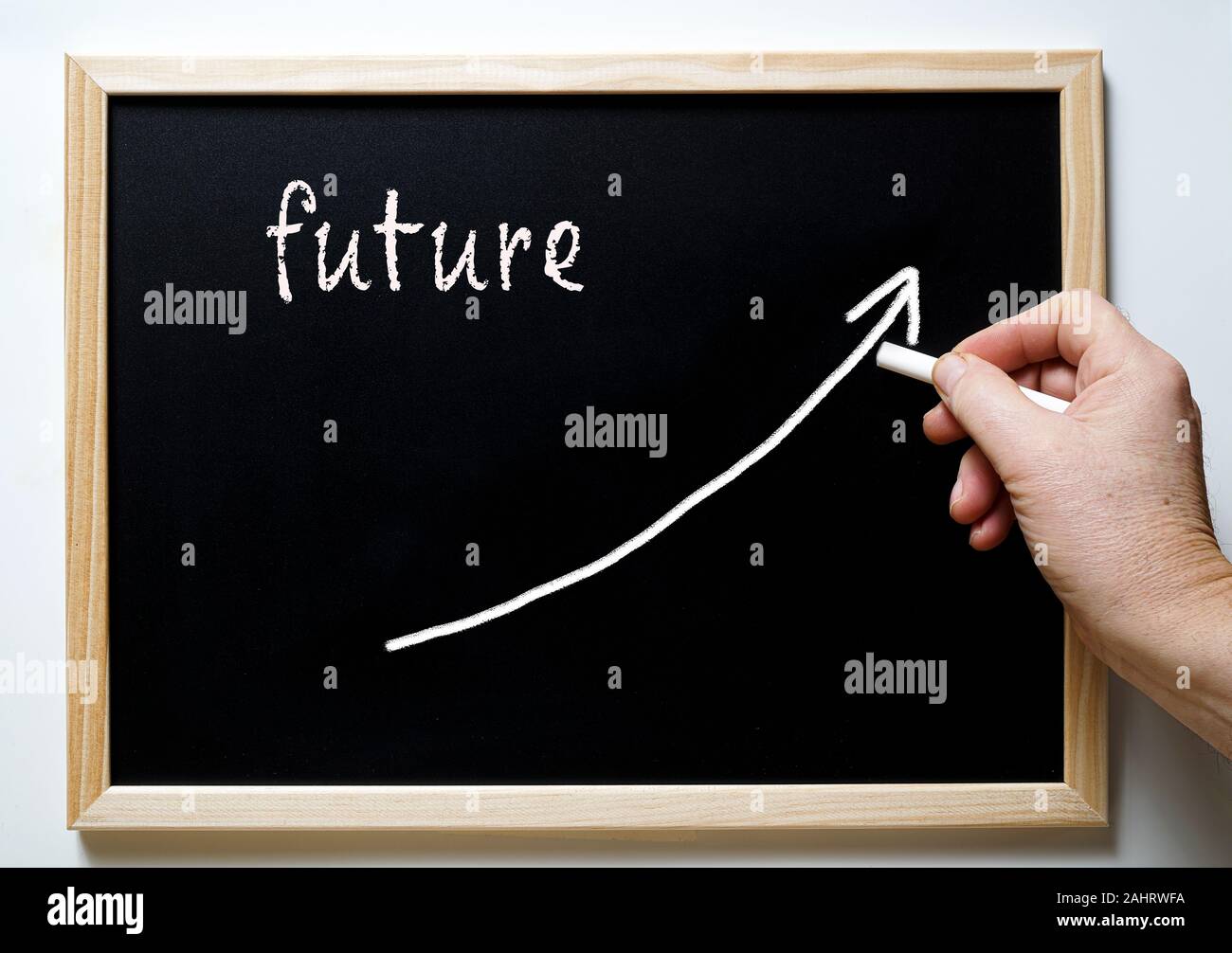 a blackboard with writing future and an arrow indicating the rise Stock Photo
