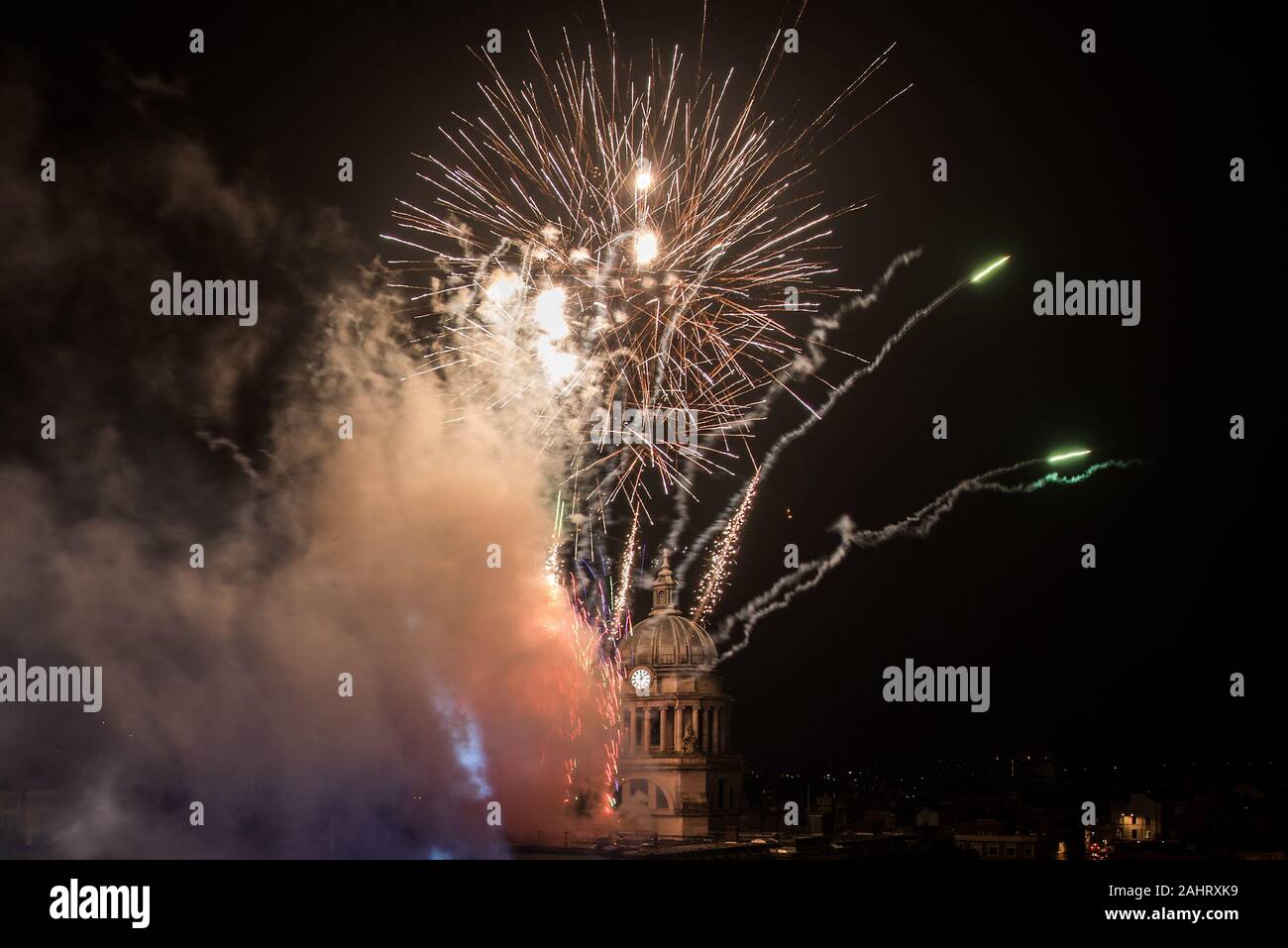 Fireworks light up the sky over the Old Market Square in Nottingham during the New Year celebrations. Stock Photo