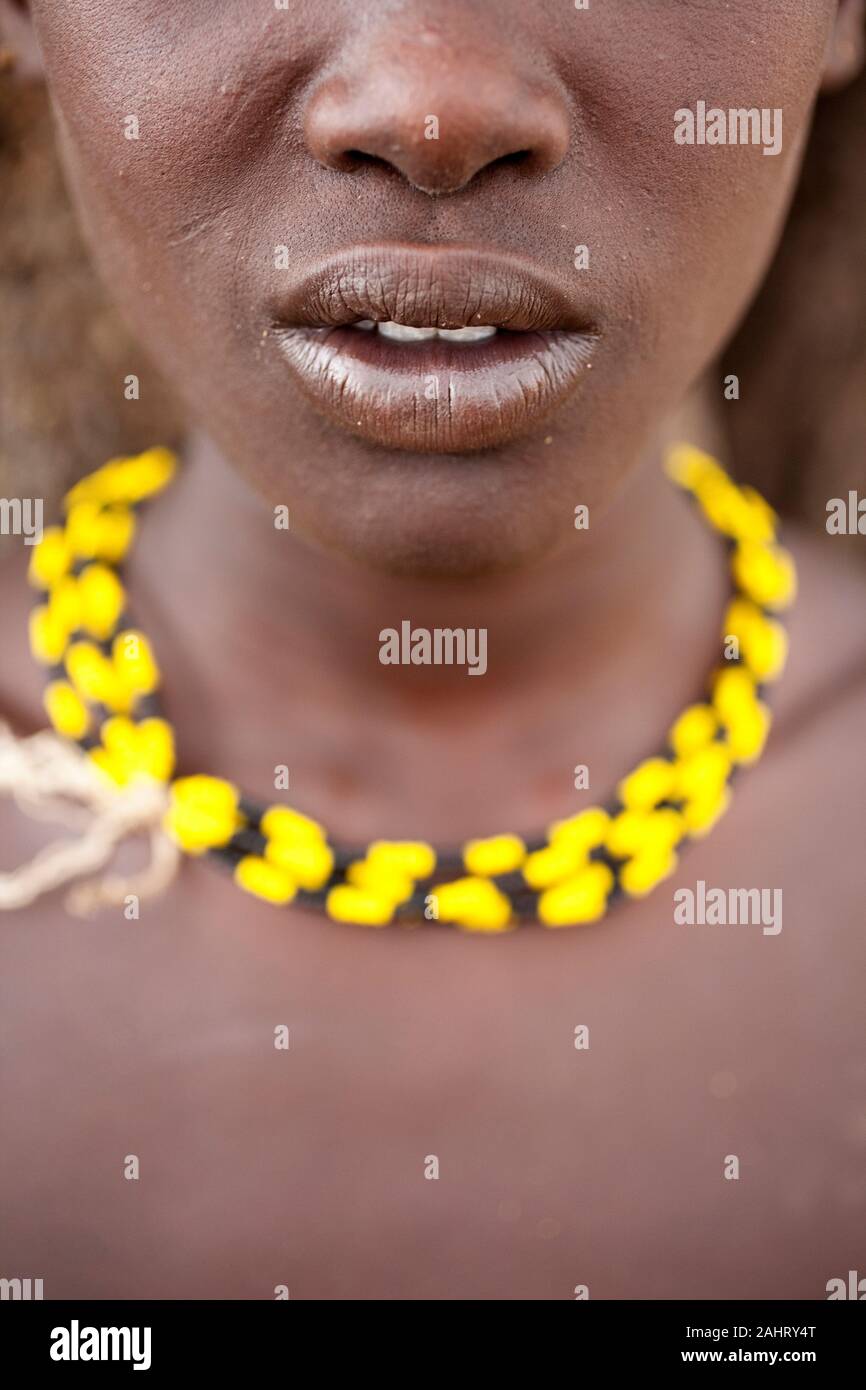 Portrait of a beautiful Dassanech girl, woman with yellow necklace, Omo valley, Ethiopia Stock Photo