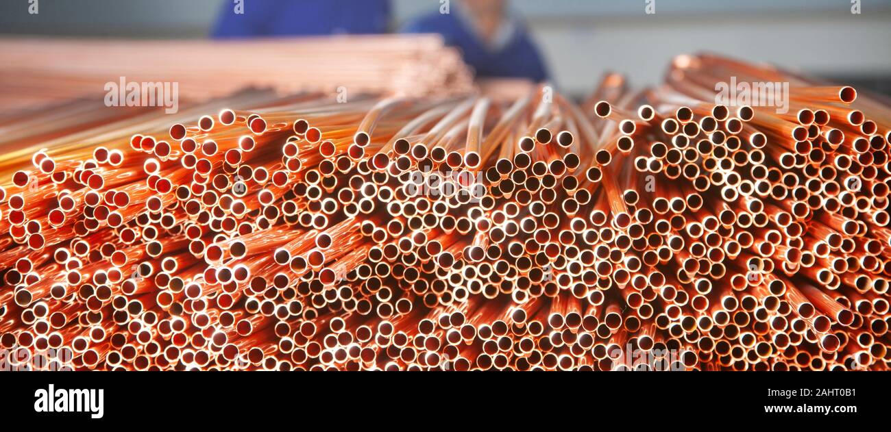 Copper pipes in factory, industrial background. Metal workers in ...
