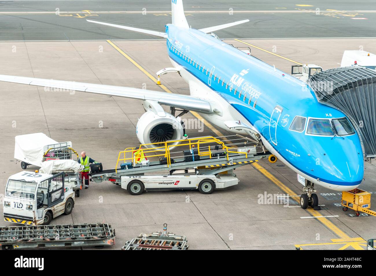 KLM Embraer E190std aircraft is loaded with baggage on the ramp at Birmingham Airport, West Midlands, UK. Stock Photo