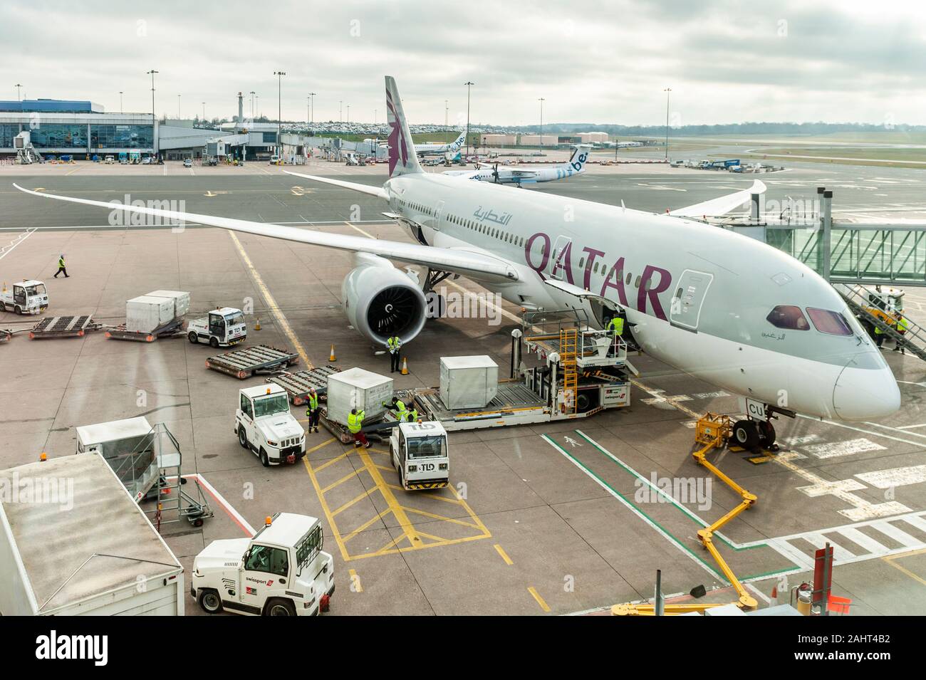 Qatar Airways Boeing 787-8 Dreamliner has passenger's luggage unloaded at Birmingham Airport, West Midlands, UK, after a flight from the Middle East. Stock Photo
