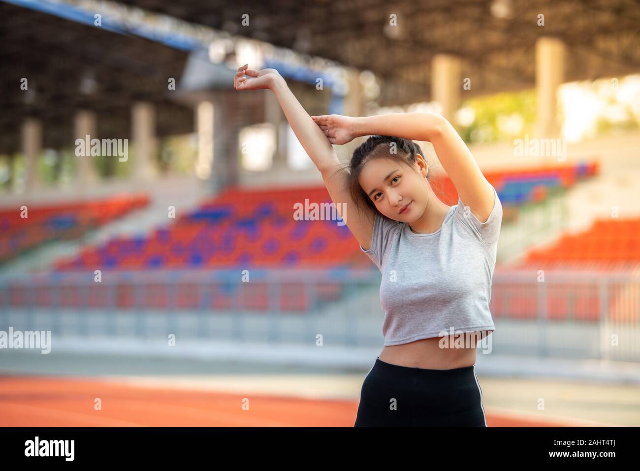 Young Asian sports woman warm up and exercising  at outdoors in morning. Stock Photo