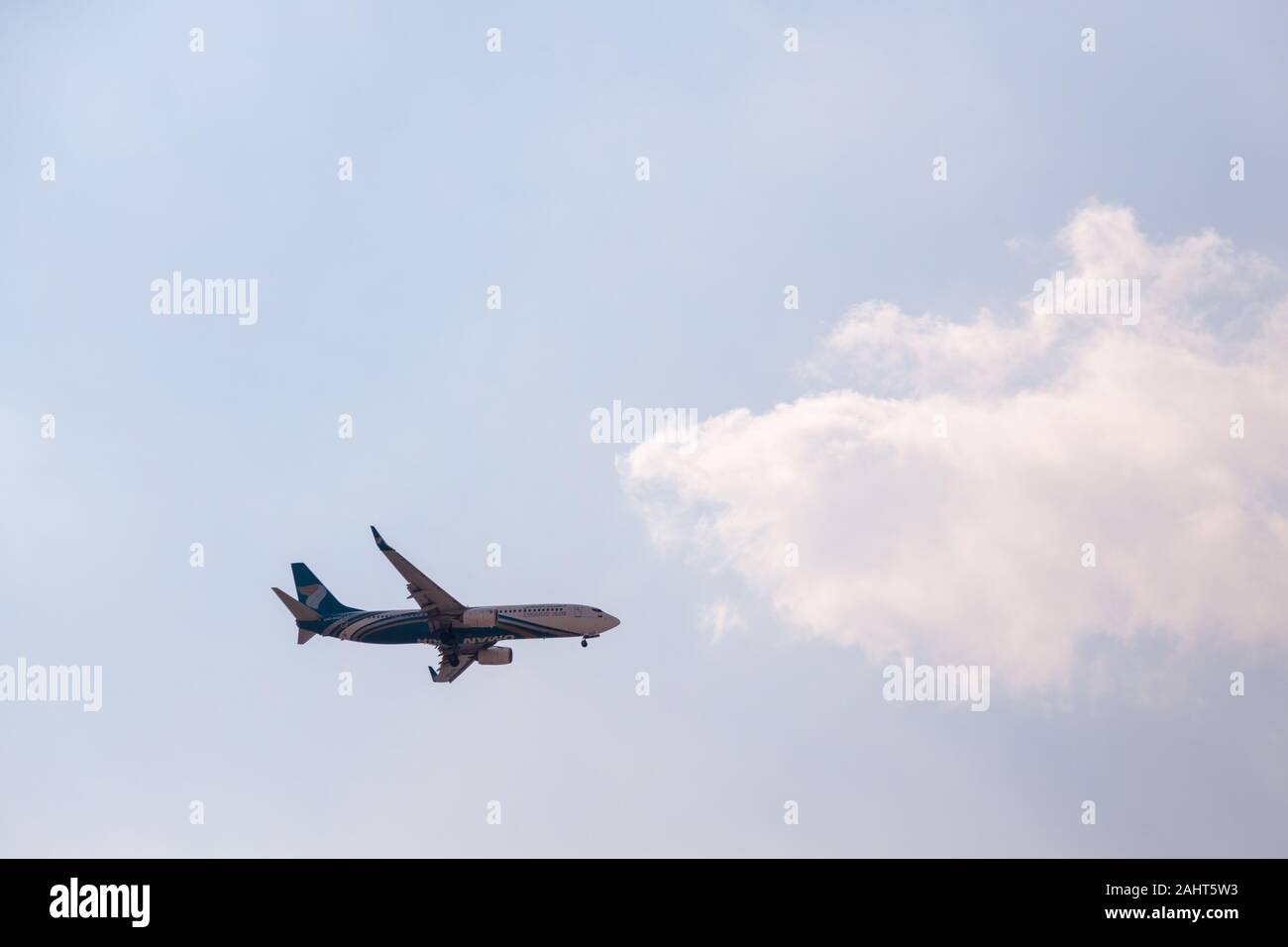 Oman Air Airline Boeing 737 approaching Dubai International Airport for landing Stock Photo