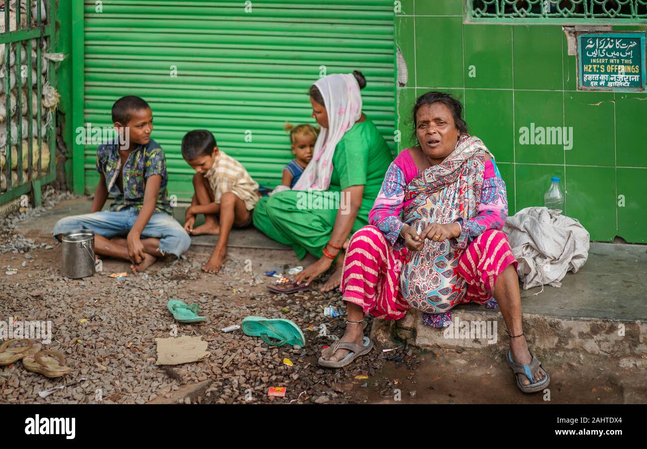 Candid portrait of poor homeless family, adults and children, living on streets near Chandni Chowk, Delhi, India. Stock Photo