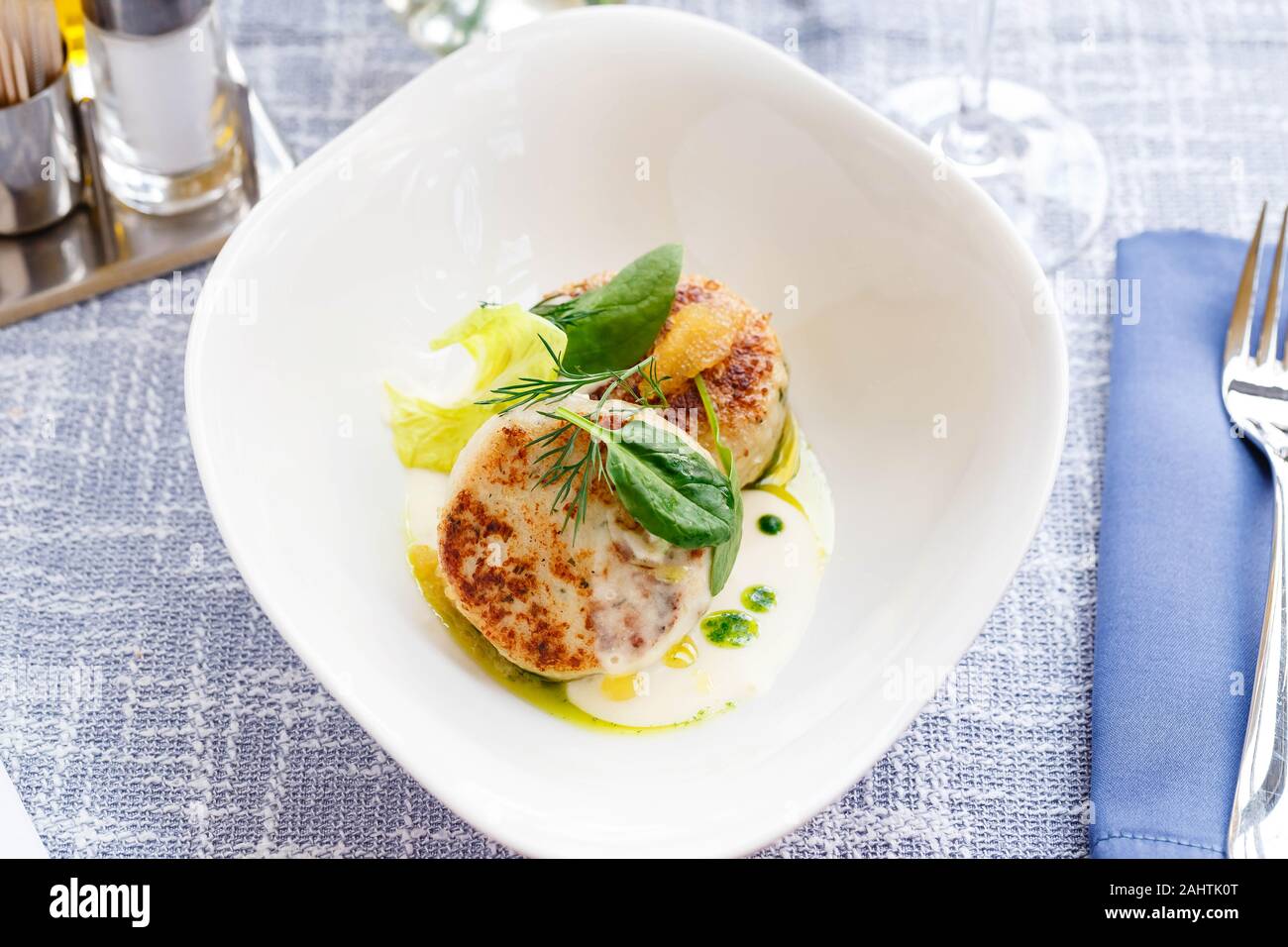 Salmon and cod fish cutlets with spinach and pike caviar with white