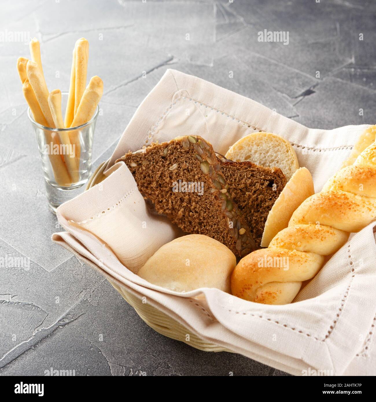 Bread basket in restaurant, freshly baked food. French pastry concept. Set of different kinds of bread and pastry. Stock Photo