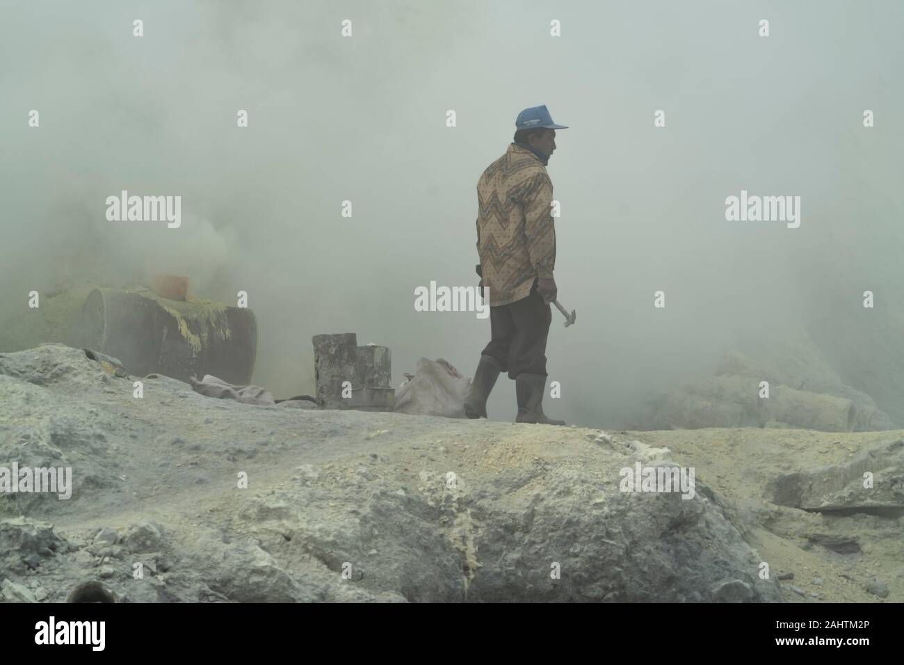 Sulphur miners work in a toxic cloud of sulphur gas in the Ijen volcano, Eastern Java, Indonesia