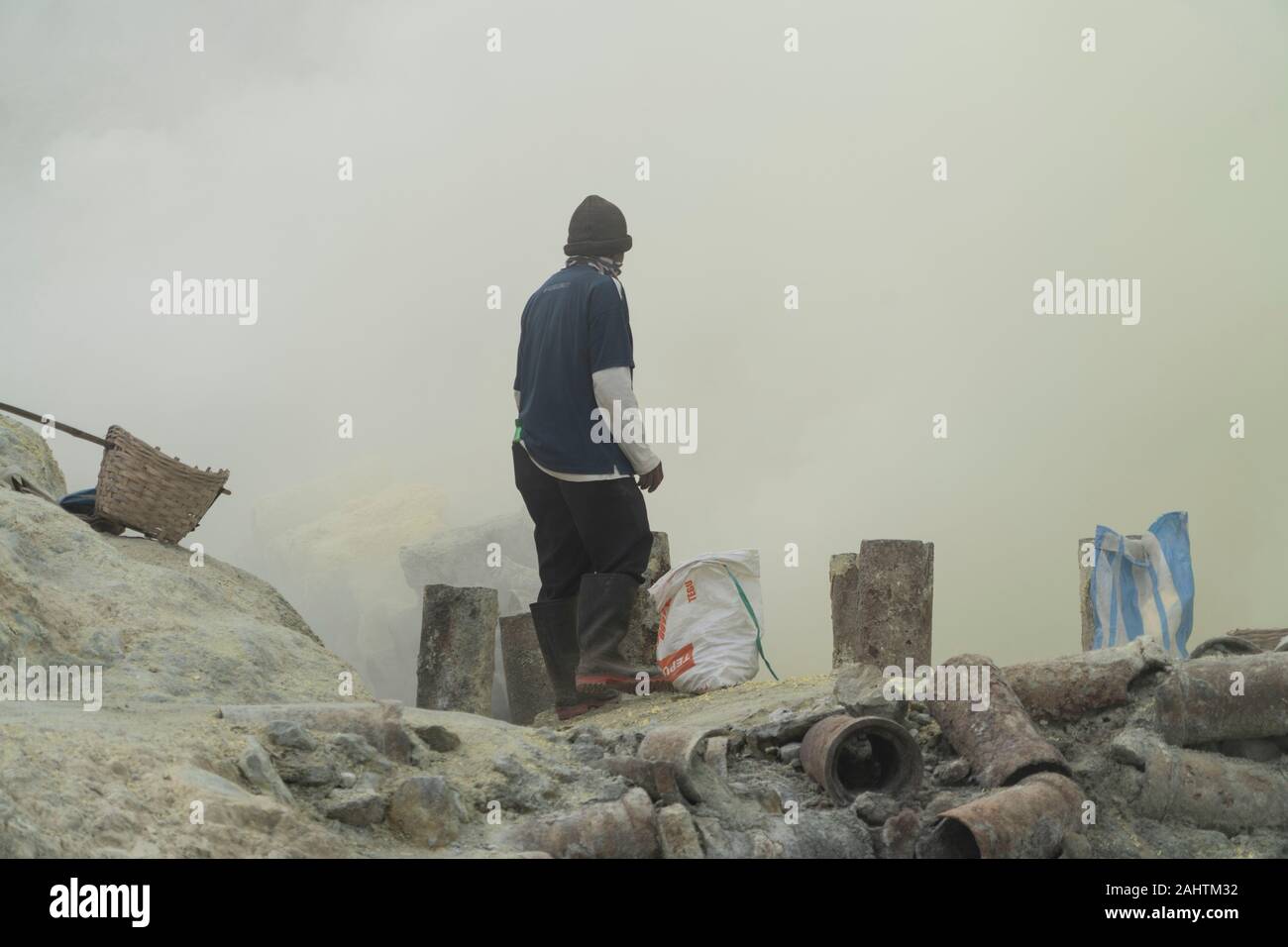 Sulphur miners work in a toxic cloud of sulphur gas in the Ijen volcano, Eastern Java, Indonesia