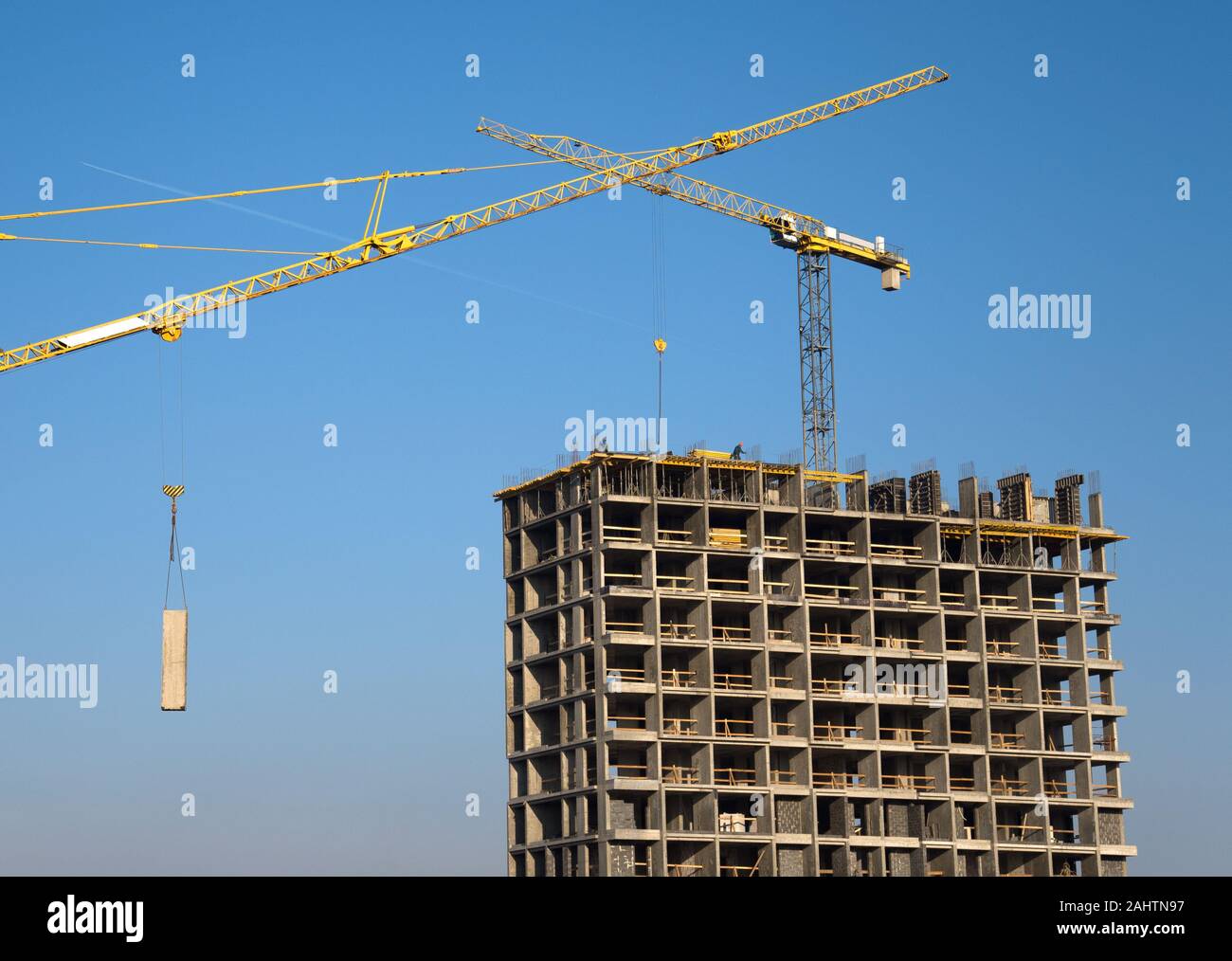 Tower crane lifts the block for building under construction at
