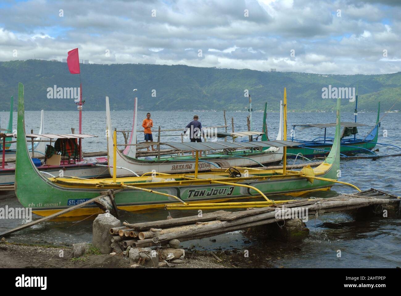 Traditional Bangka boats docked on the shore of Taal Lake on Taal