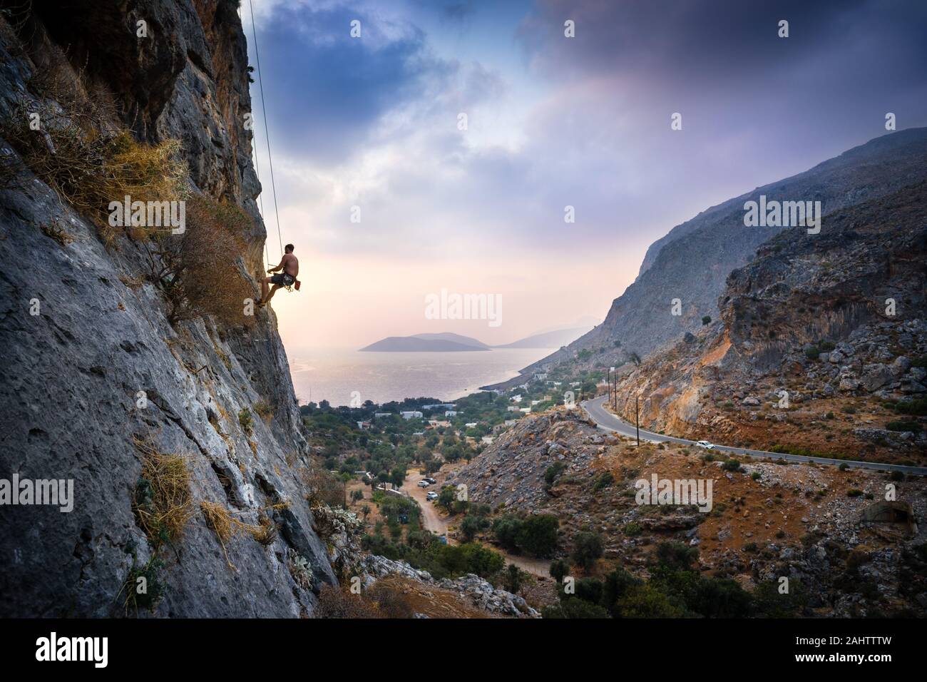 Beautiful Sunset Landscape With Man Lowering Off A Hard Rock Climb On Kalymnos Island, Greece. Stock Photo