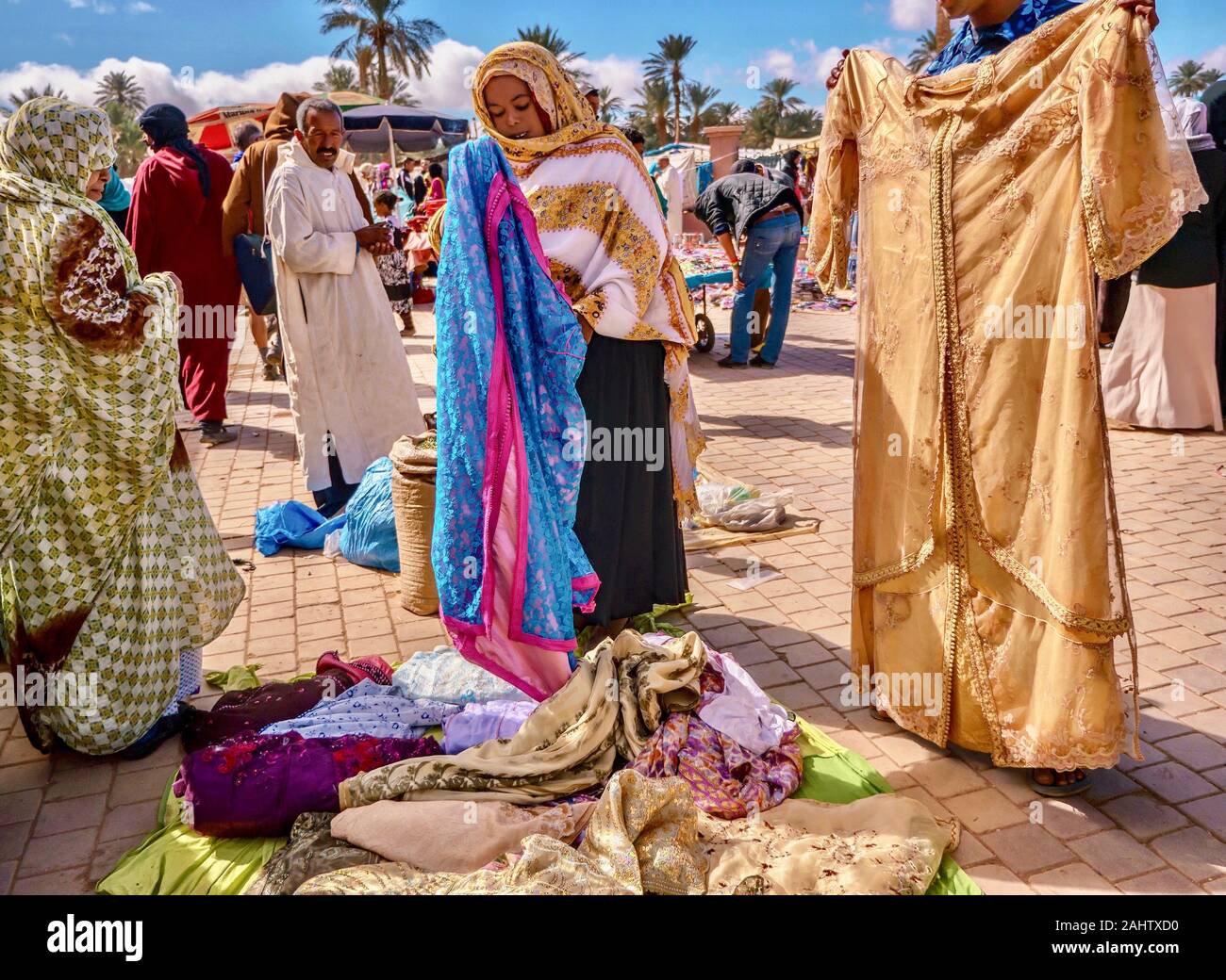 Tamegrout, Morocco - Oct 24, 2015. An outdoor market where Moroccan shoppers are looking at clothing being sold by a street vendor. Stock Photo