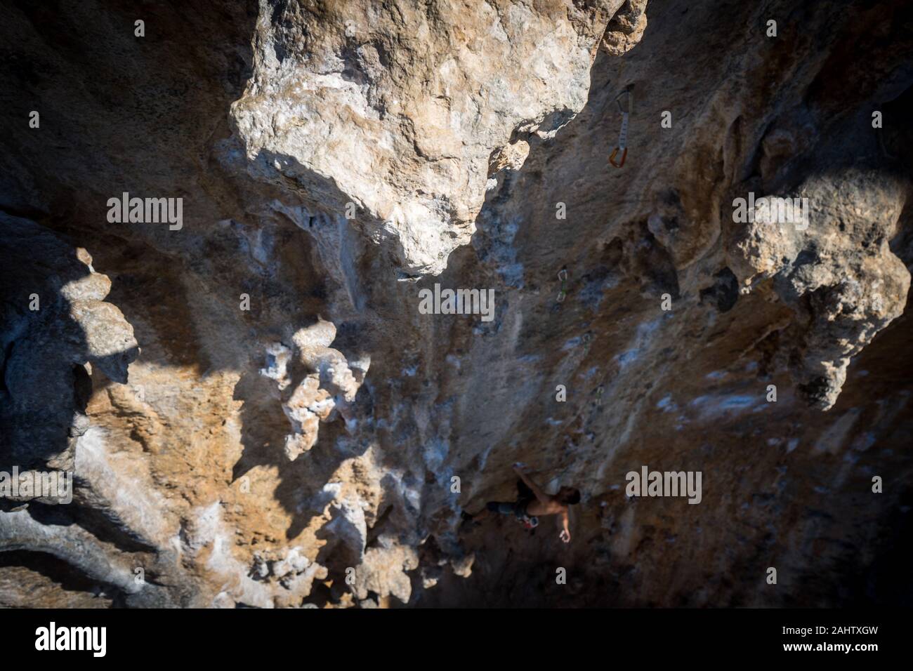 Man Leading Hard Rock Climbing Route, Fantasma at Ghost Kitchen in Kalymnos, Greece. Stock Photo