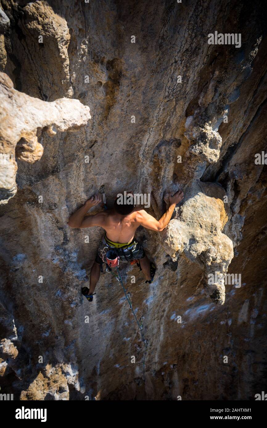 Man Leading Hard Rock Climbing Route, Fantasma at Ghost Kitchen in Kalymnos, Greece. Stock Photo
