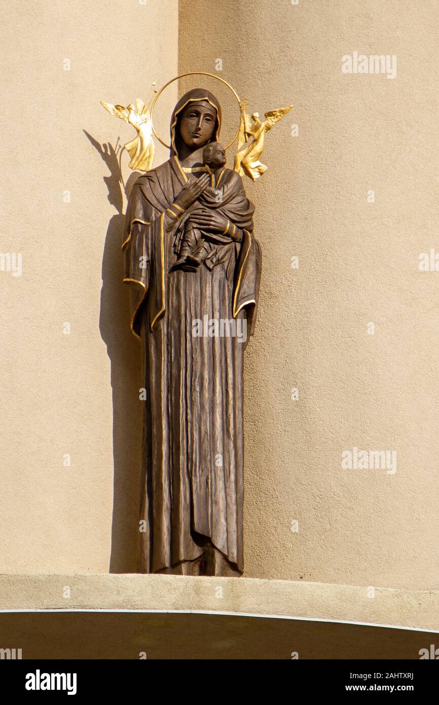 Statue of the Mother of Perpetual Help above the entrance to a church. Stock Photo