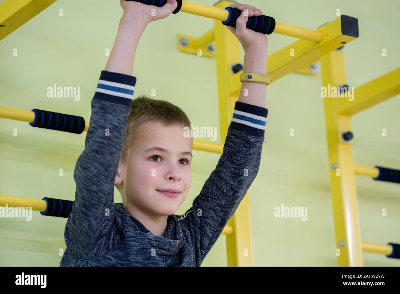 Children Exercise Rails Young child boy exercising on a wall ladder bar inside sports gym room ...