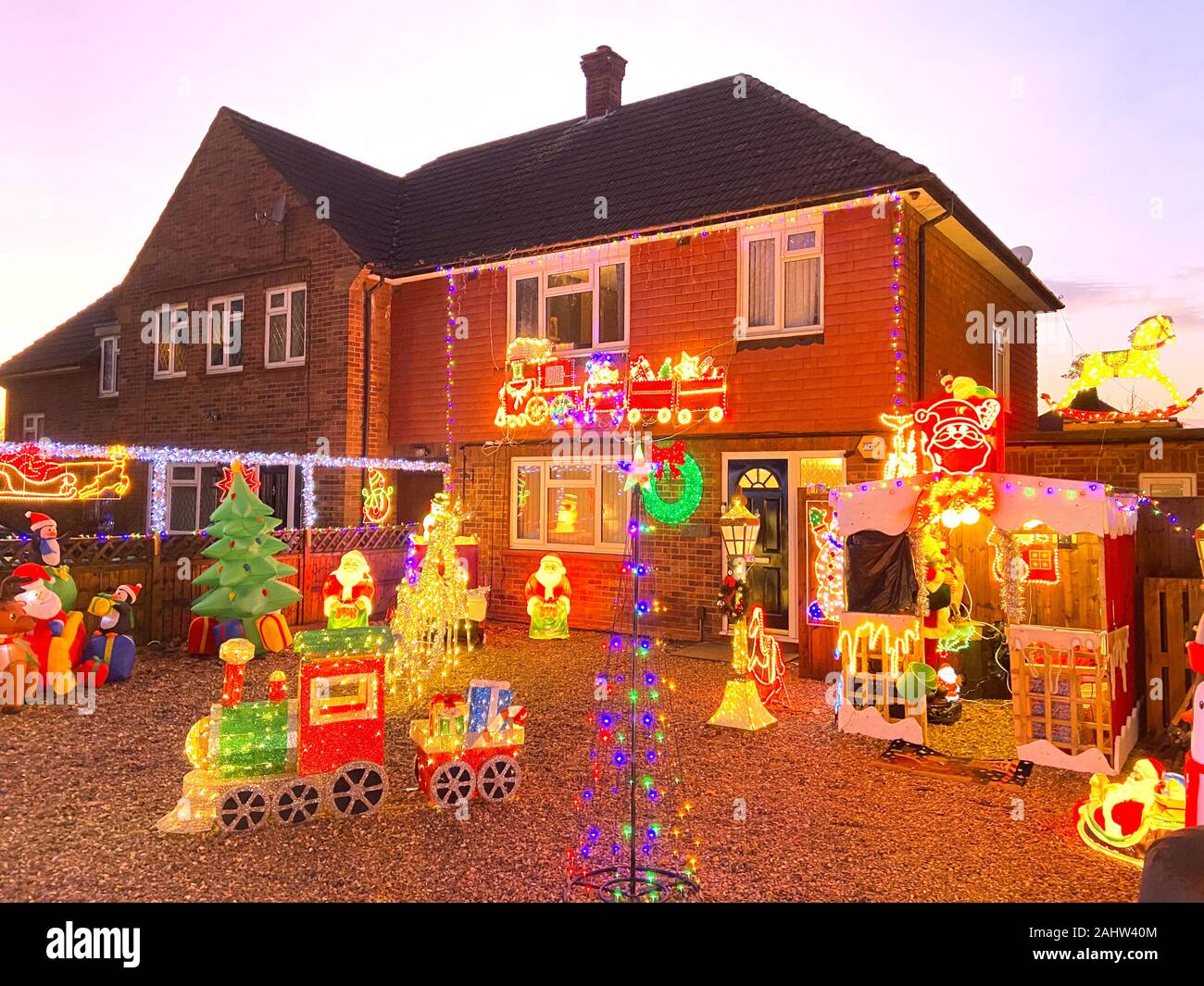 House with Christmas lights and decorations at dusk, Ashford Road, Laleham, Surrey, England, United Kingdom Stock Photo