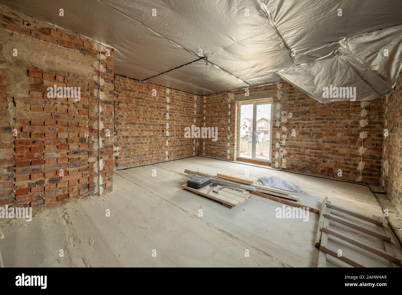 Interior Of Unfinished Brick House With Concrete Floor And