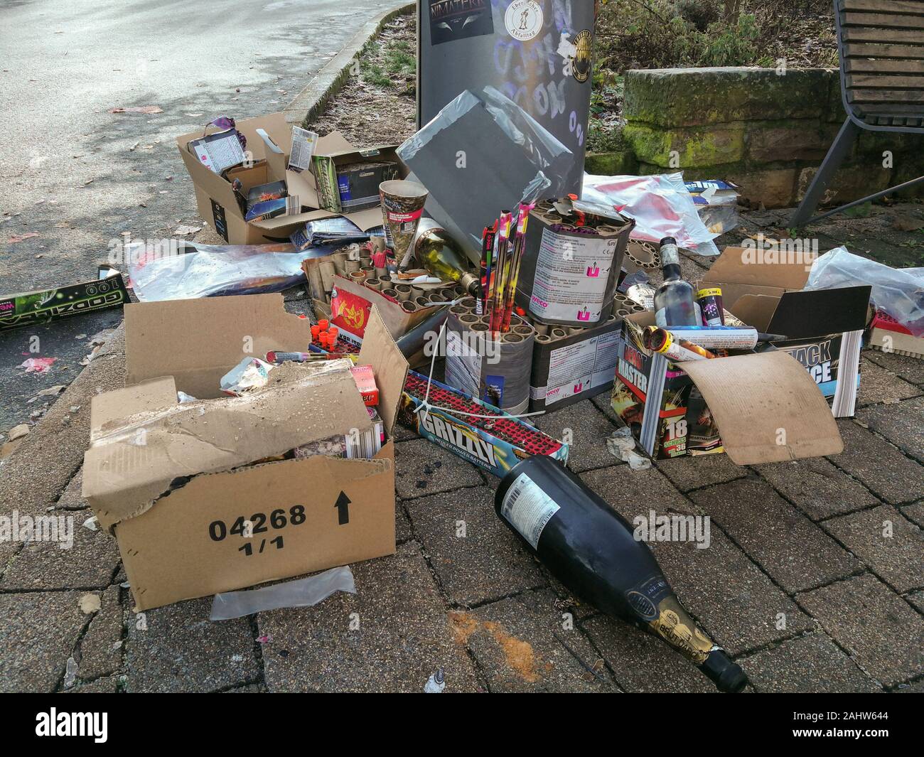 NECKARGEMÜND, GERMANY - JAN. 1, 2020: Remains of celebrations into the new year, used up fireworks and empty wine  bottles at a public bin Stock Photo