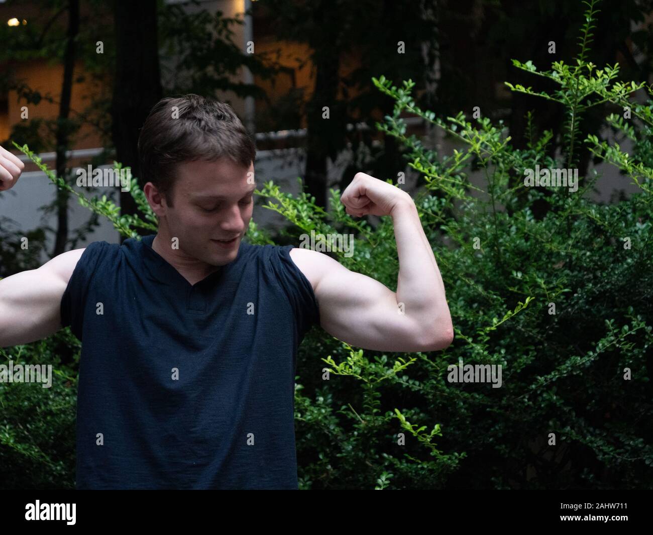 A man showing off muscles hi-res stock photography and images - Alamy