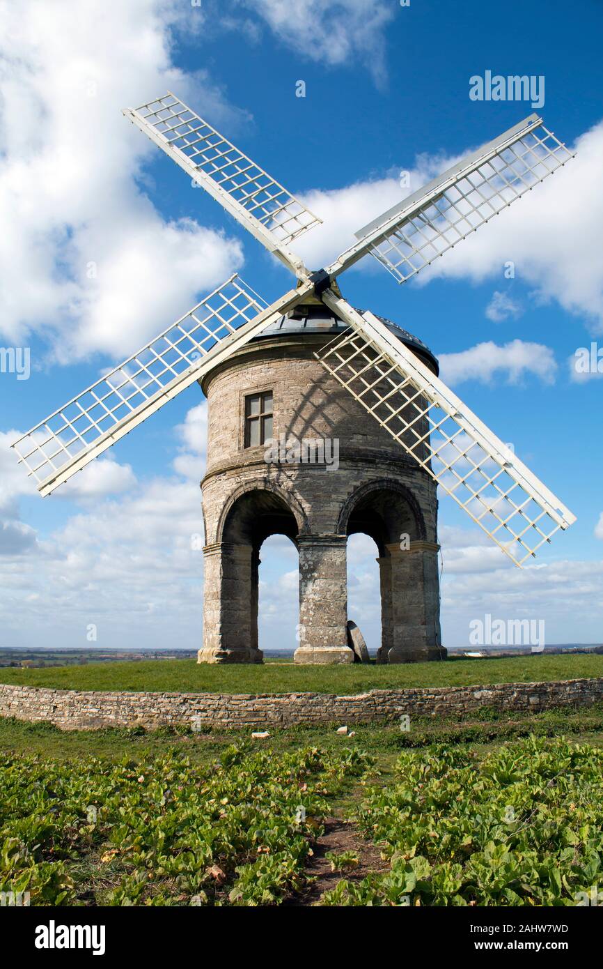 Chesterton, West Midlands, UK - March 25, 2016: Chesterton 17th-century cylindrical stone tower windmill against a blue sky with clouds Stock Photo