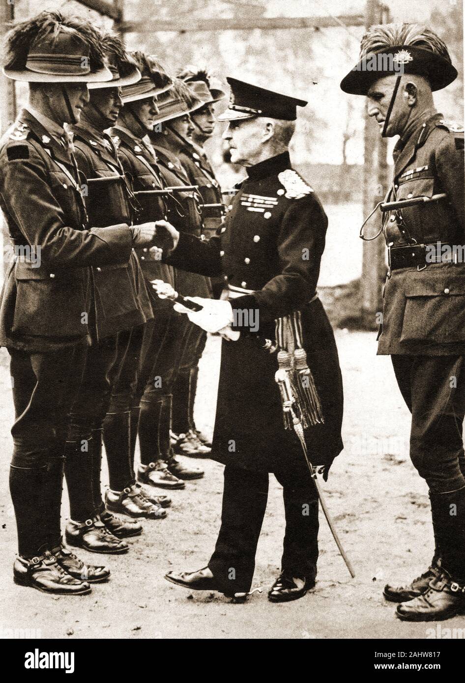 May 8th 1937. Field Marshal Lord Caven ( Frederick Rudolph Lambart 1865-1946)  shakes hands with Colonel Barker at Pirbright Camp,   - The  Australian colonel Edmund Frank Lind (1888-1944) is behind him. Lord Cavan was previously known as Viscount Kilcoursie . Stock Photo