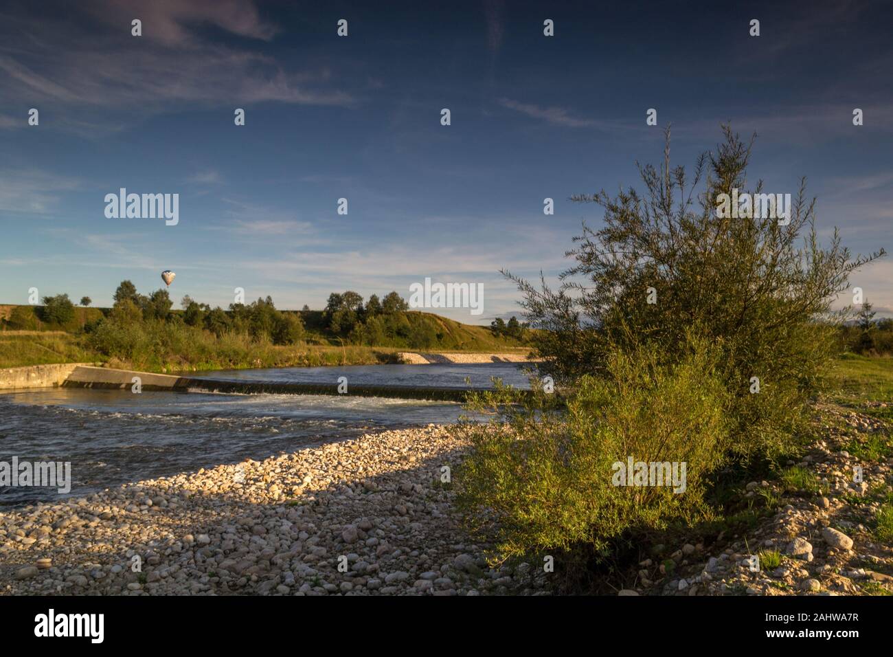 View of the Czarny Dunajec river and distant mountains. Stock Photo