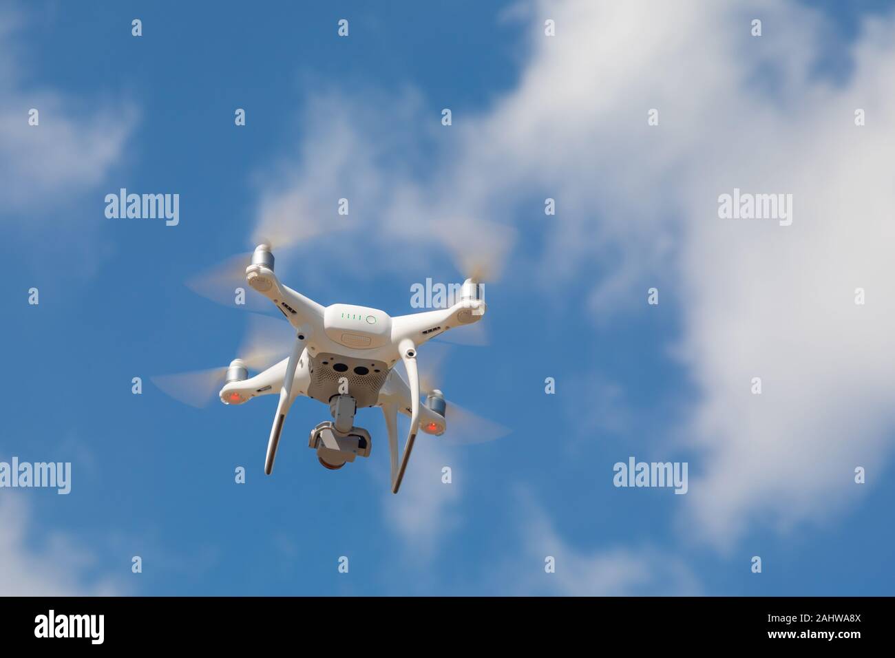 Drone Quadcopter From Below Against A Blue Sky. Stock Photo