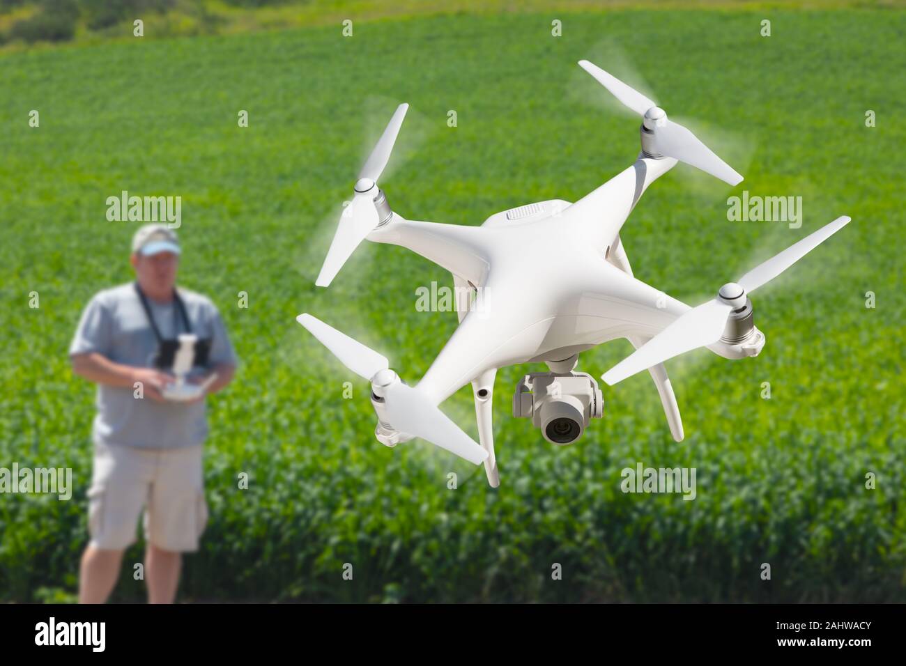 Pilot Flying Unmanned Aircraft Drone Gathering Data Over Country Farmland Field. Stock Photo