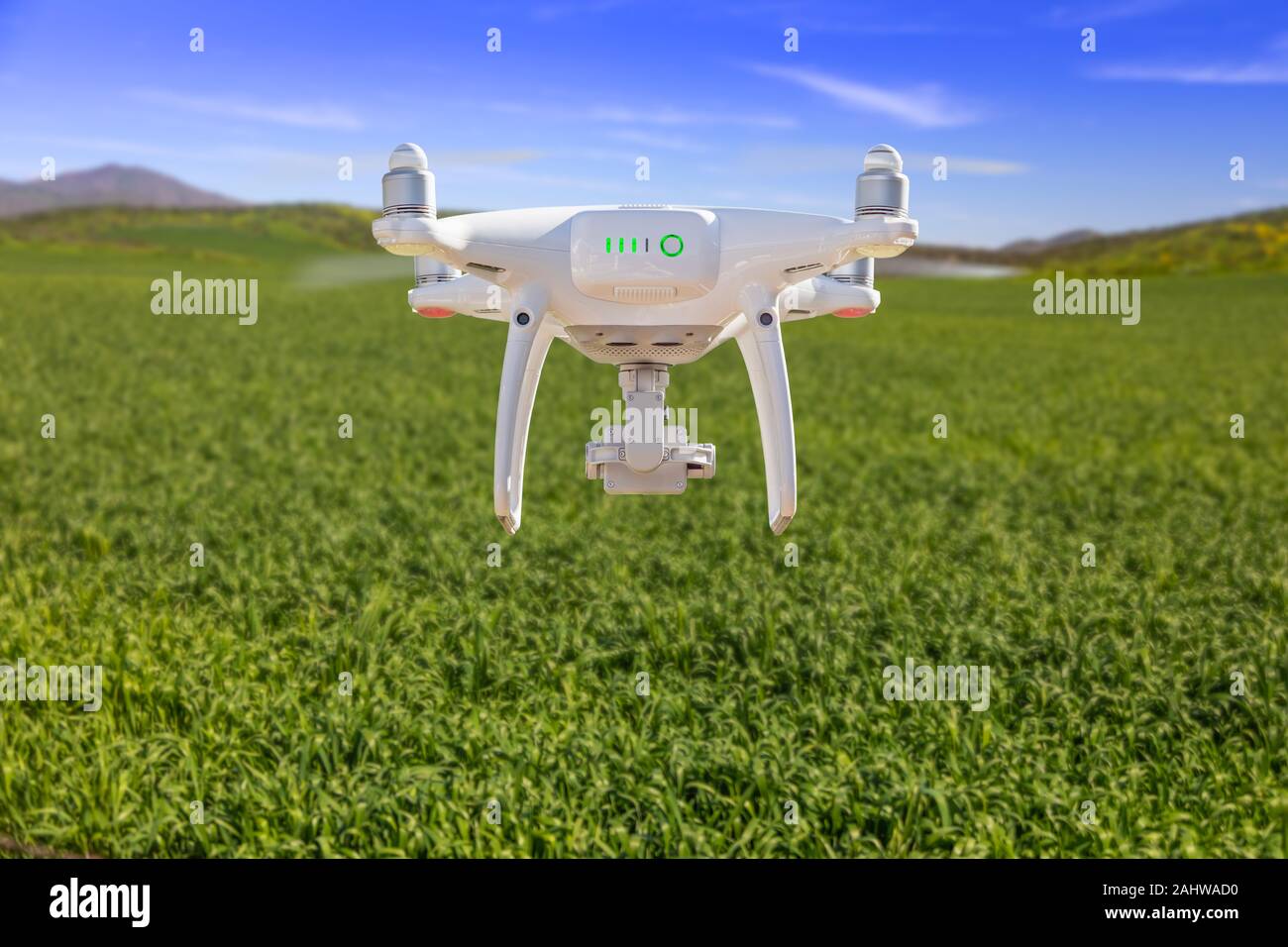 Drone Unmanned Aircraft Flying and Gathering Data Over Country Farmland. Stock Photo