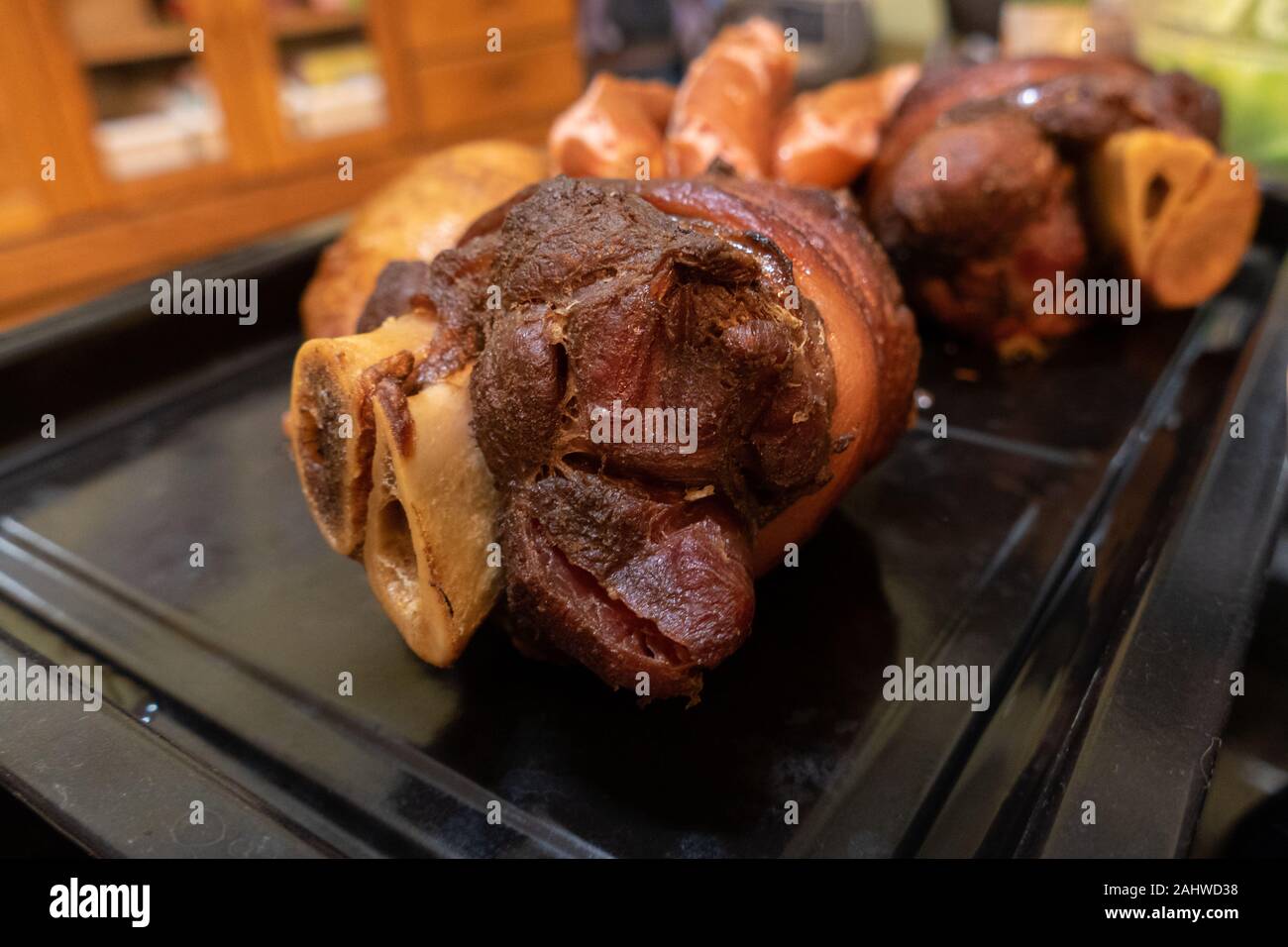 German pork knuckle Schweinshaxe in baking tray, closeup Stock Photo