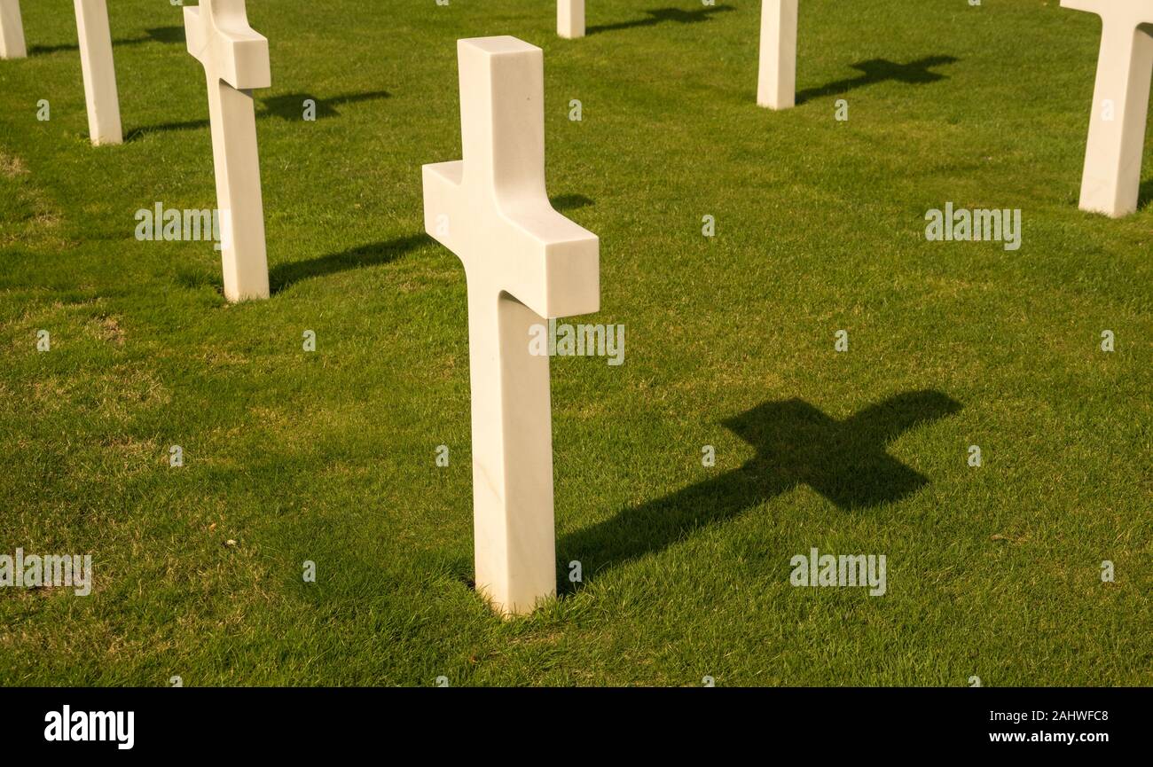 Multiple rows of white crosses in cemetery Stock Photo