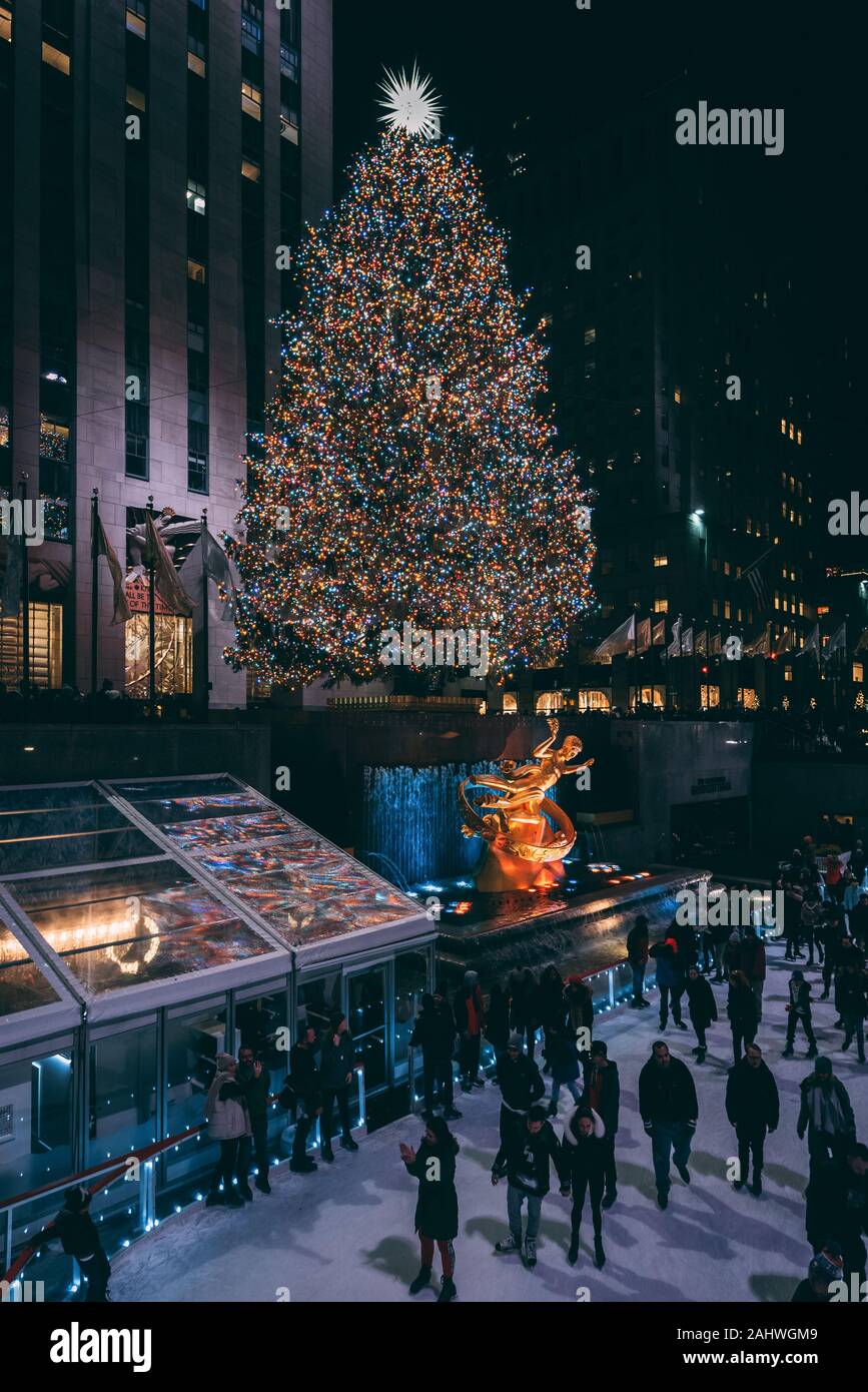 Christmas tree and ice skating rink at Rockefeller Center at night, in