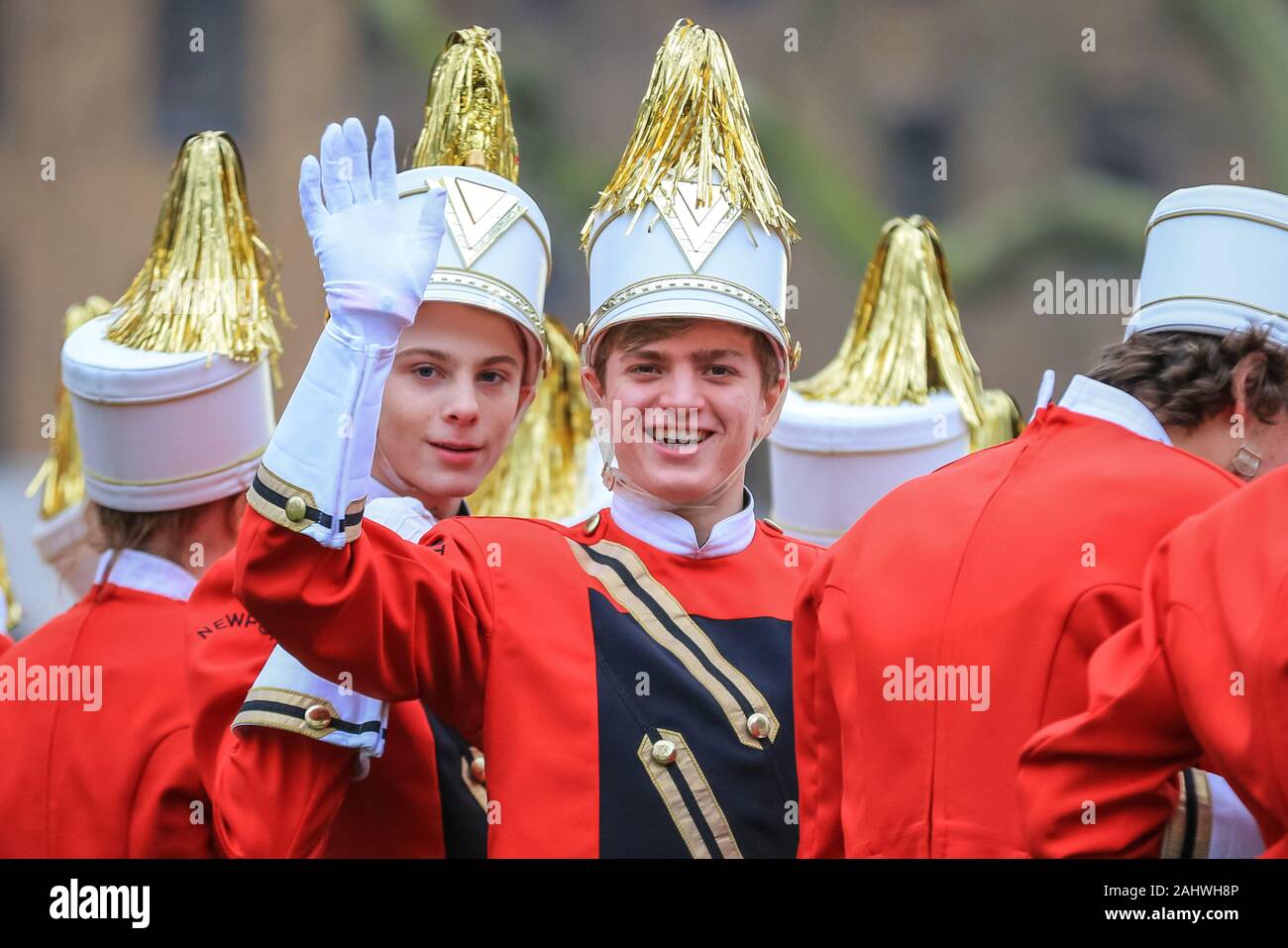 Central London, 1st Jan 2020. Participants with a High School Band wave ...