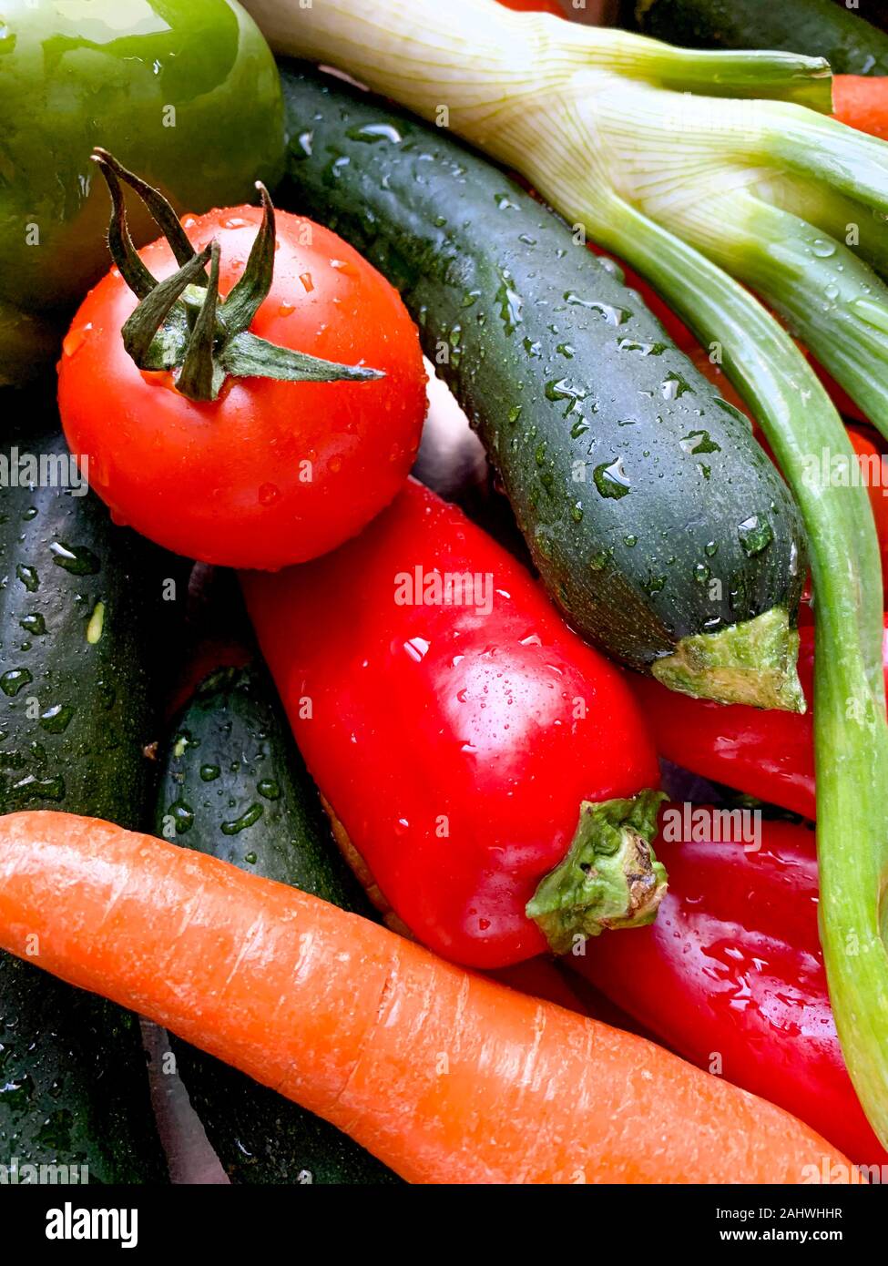 Overhead view of various vegetables with drops of water arranged on a kitchen,, Mediterranean food, Spain Stock Photo