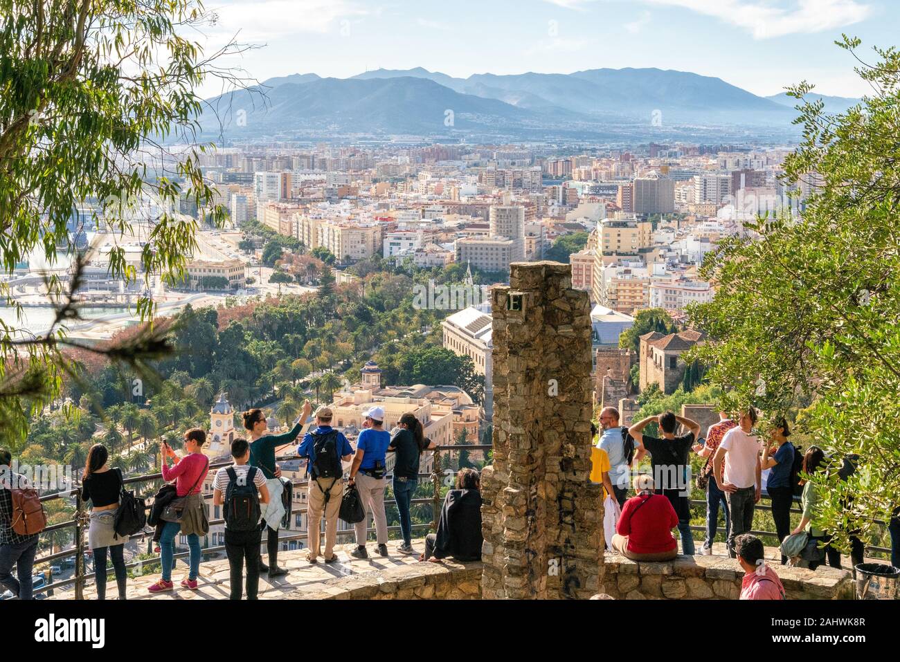 25th December 2019 - Malaga, Spain. People enjoy views over Malaga city from a viewpoint towards Gibralfaro castle. Stock Photo