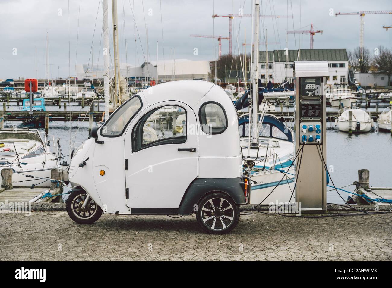 small electro car charging in street seafront in Copenhagen, Denmark