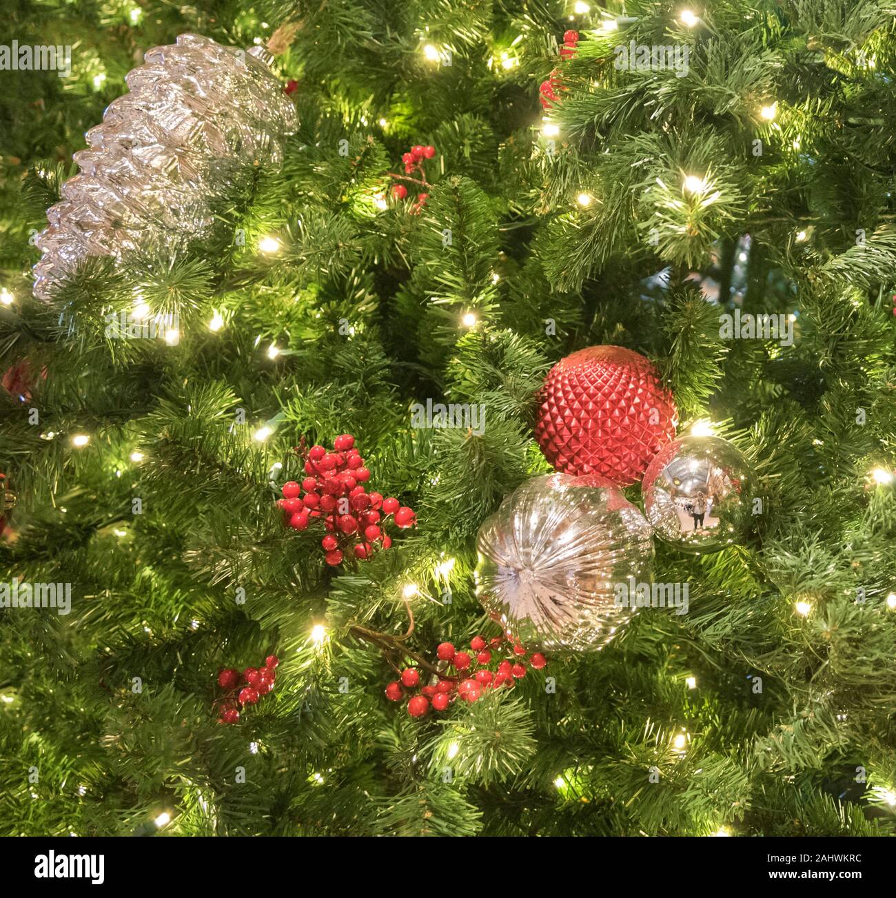 Christmas decorations hanging on a large Christmas tree Stock Photo Alamy