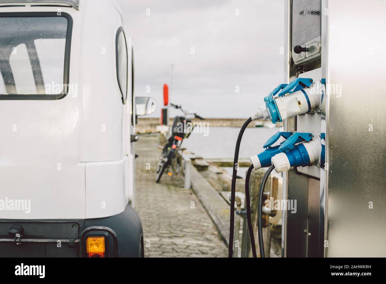 small electro car charging in street seafront in Copenhagen, Denmark