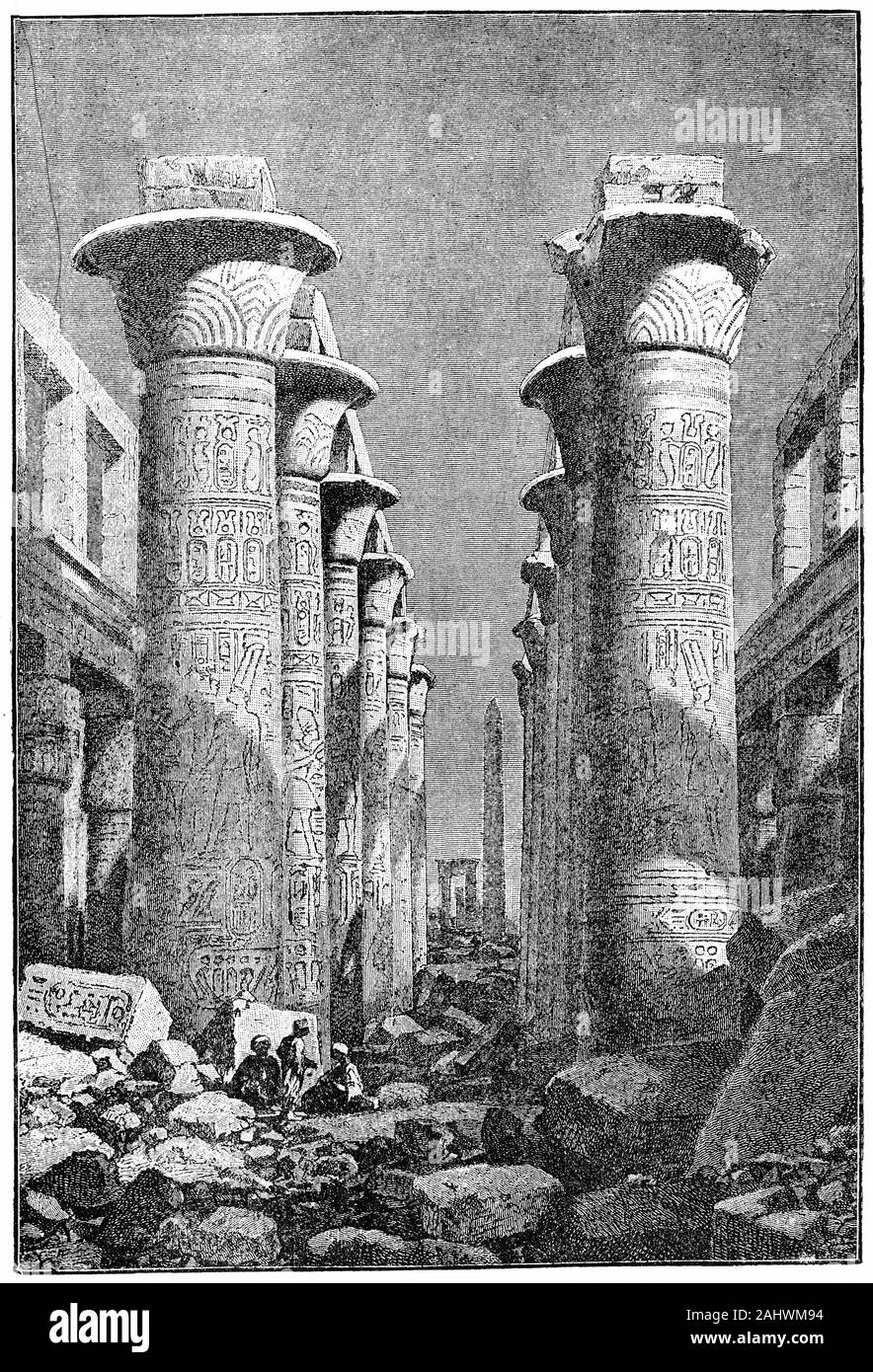 Engraving of columns in The Karnak Temple Complex, commonly known as Karnak, a vast mix of decayed temples, chapels, pylons, and other buildings near Luxor, in Egypt. Construction at the complex began during the reign of Senusret I in the Middle Kingdom and continued into the Ptolemaic period, although most of the extant buildings date from the New Kingdom. Stock Photo