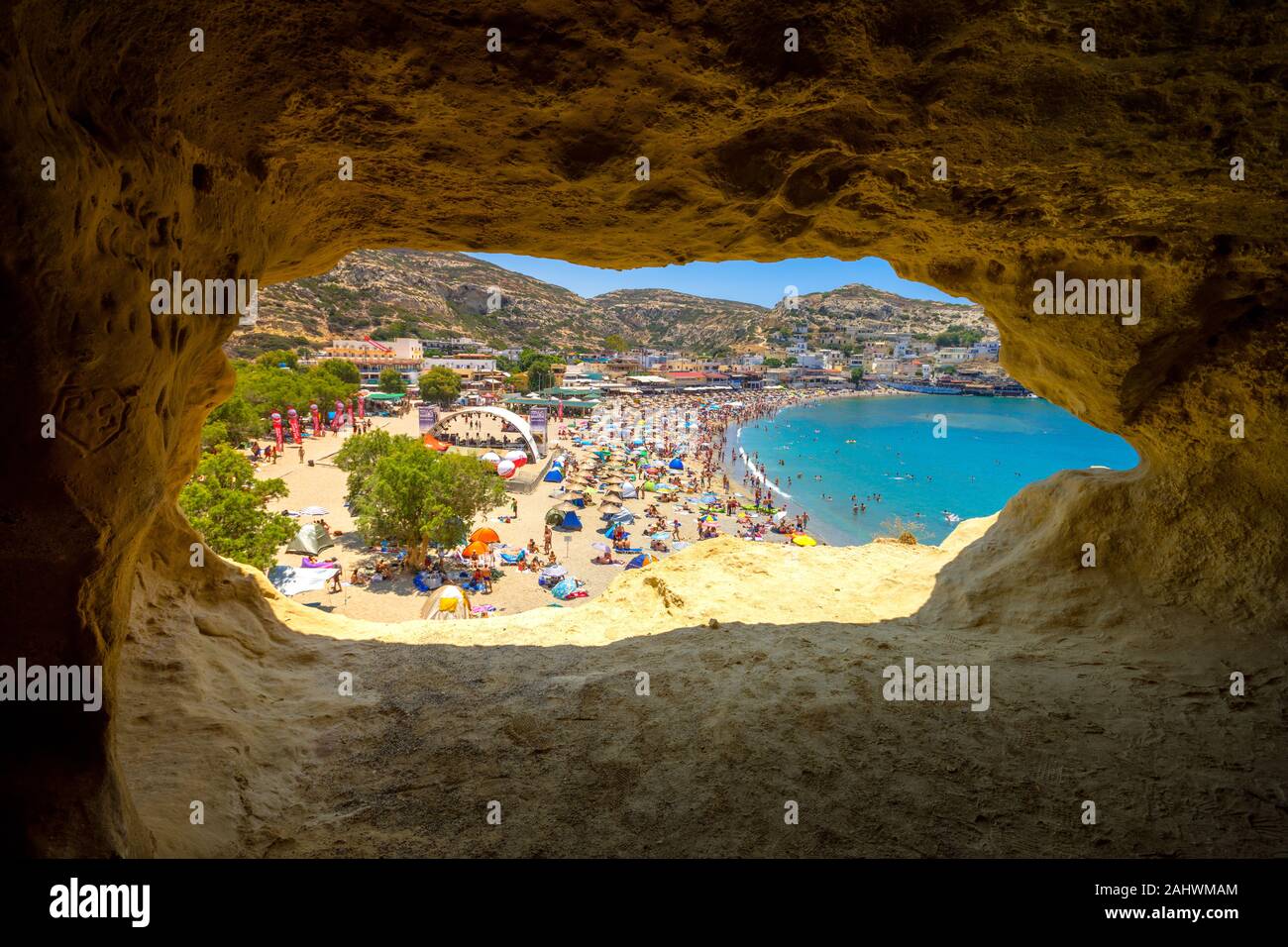 Matala beach with caves on the rocks that were used as a roman cemetery and at the decade of 70's were living hippies, Crete, Greece. Stock Photo